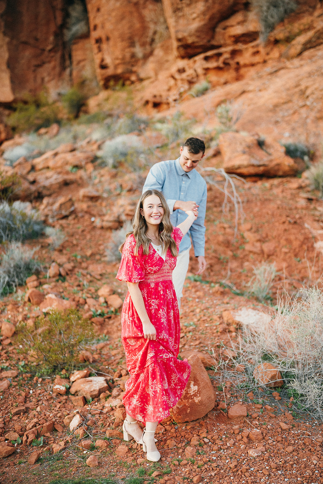 engaged couple hiking in the red rocks