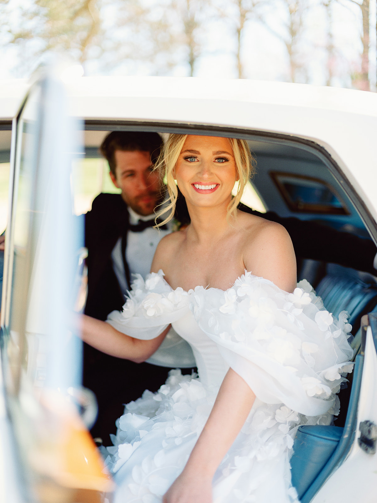 Bride sitting in classic rolls-royce car