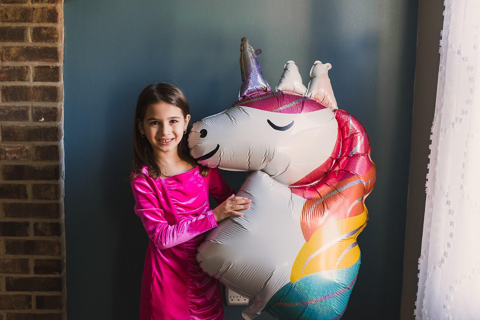 Girl holding unicorn balloon