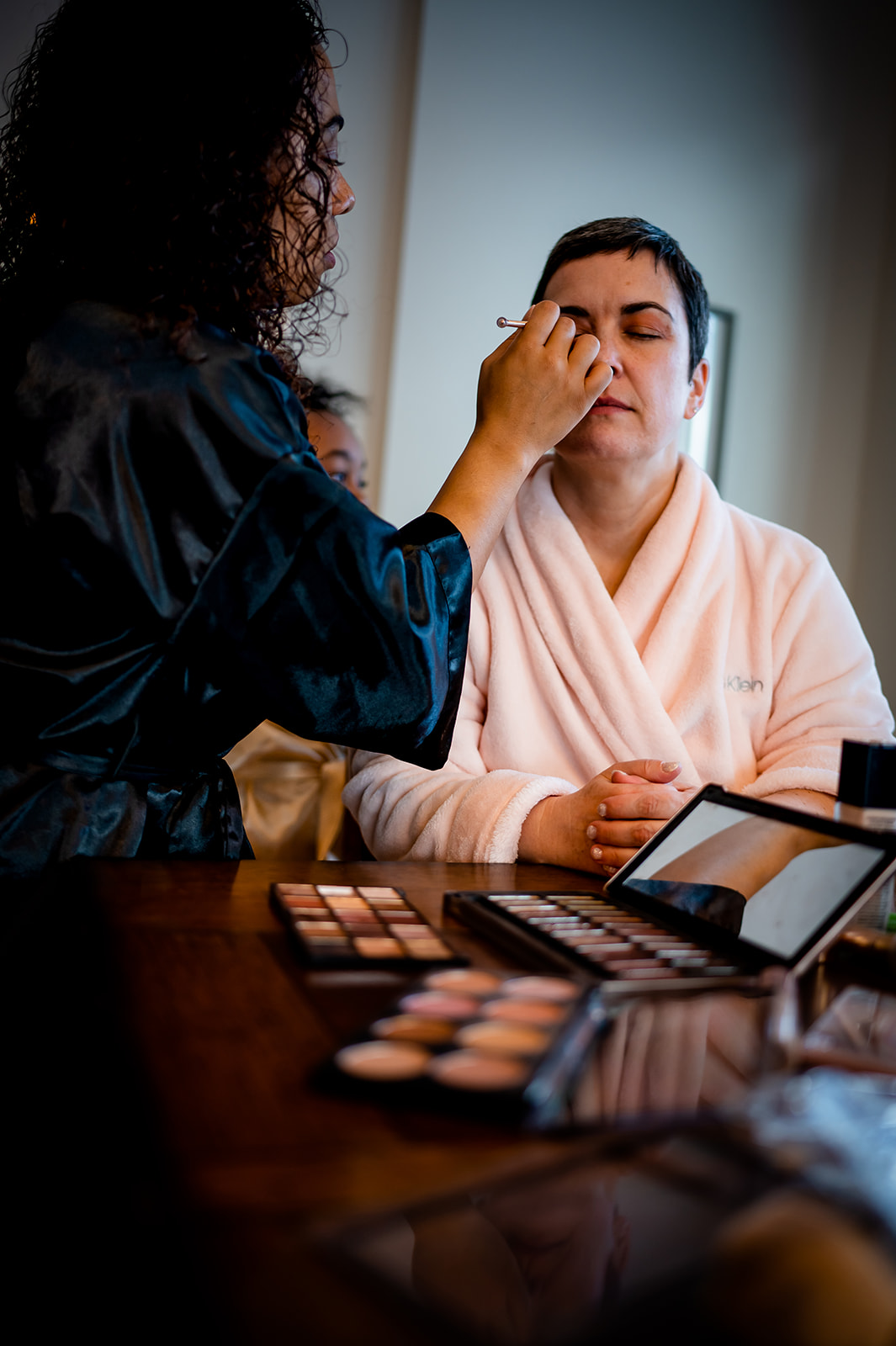 a bride gets her makeup done by her daughter on her elopement day in Colorado