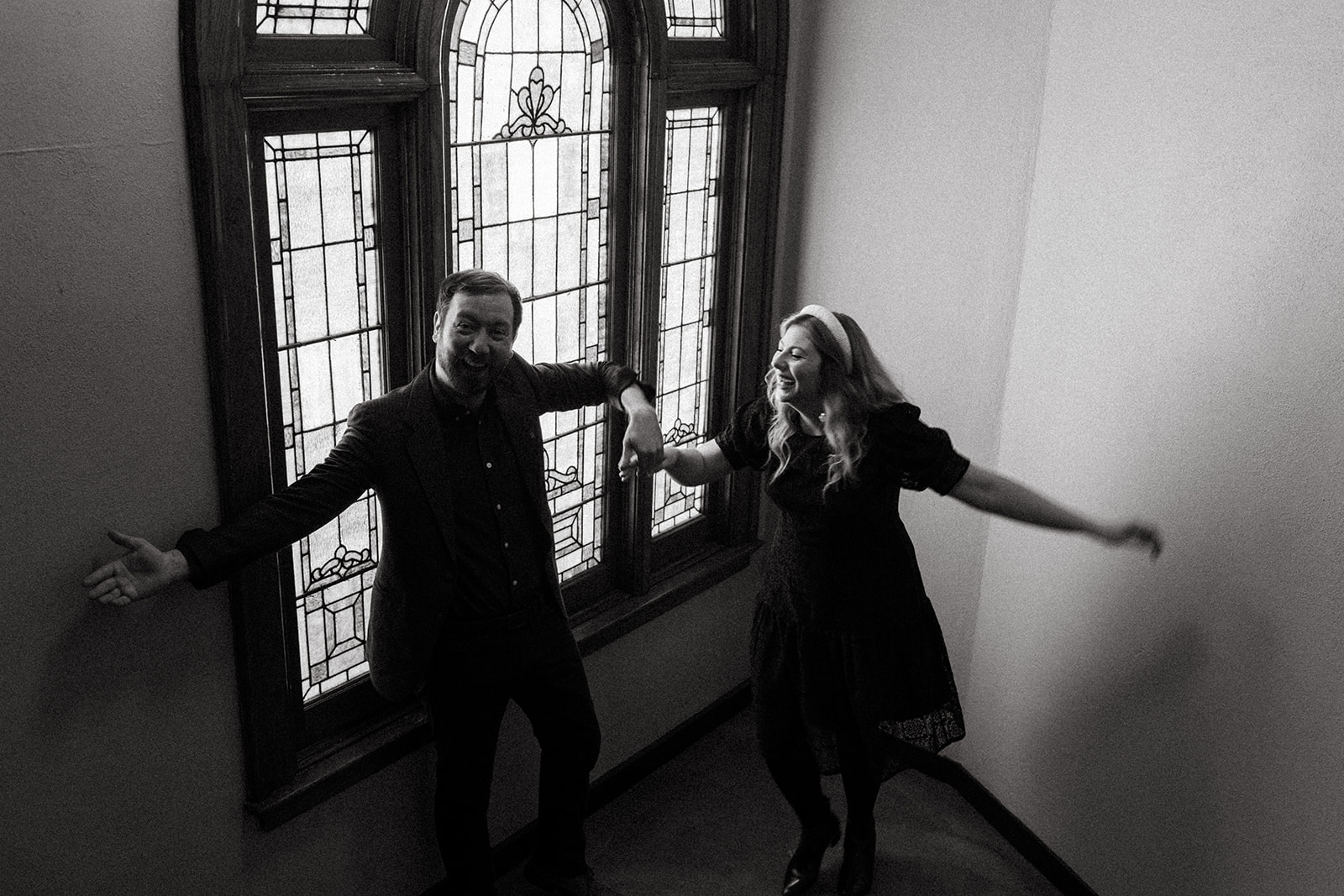 black and white photo of couple laughing and dancing during cincinnati engagement photos