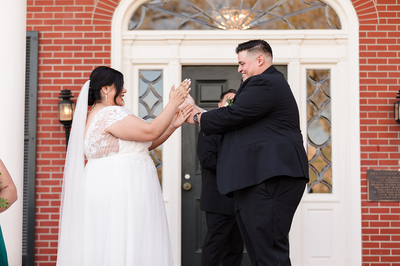 Bride and groom share a secret handshake after they exchange wedding rings