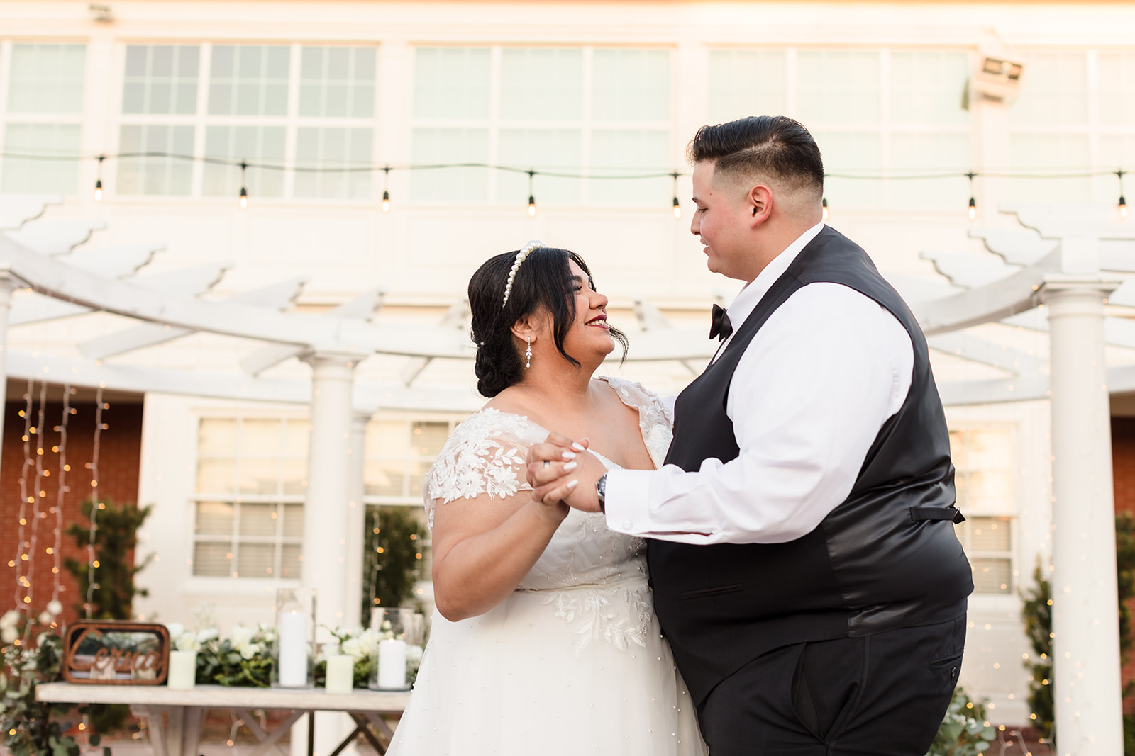 Newlyweds share their first dance in the courtyard at Crestmore Manor