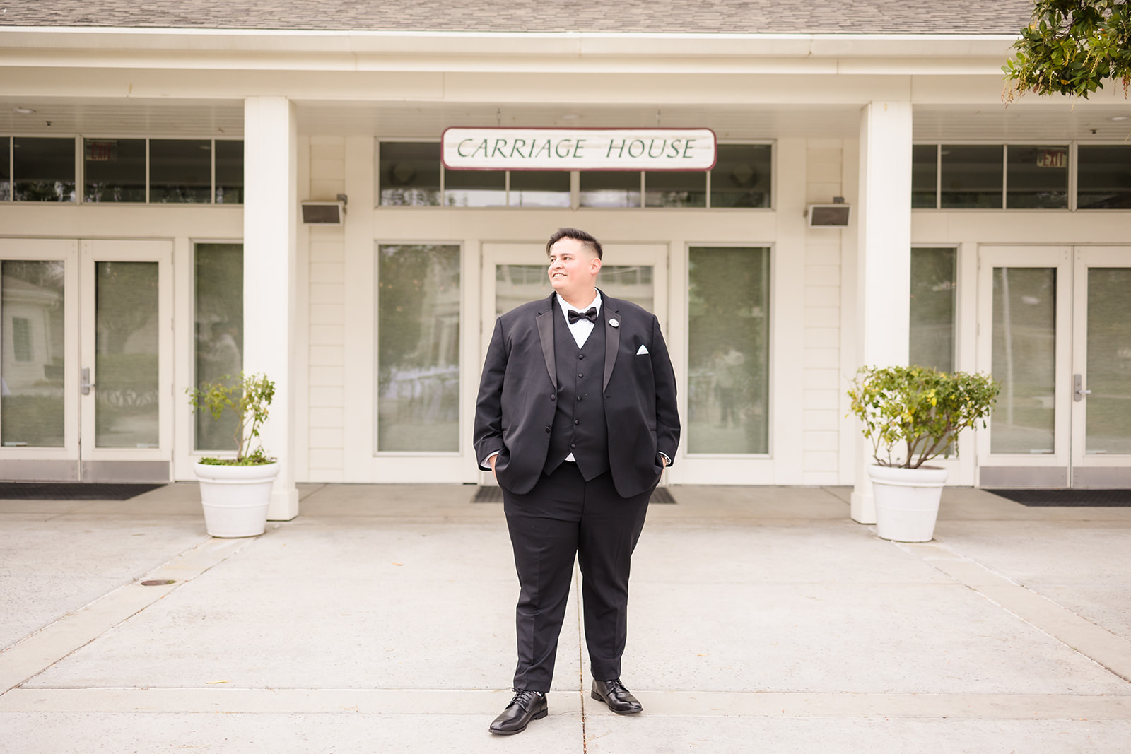 Groom portrait in front of Crestmore Manor Carriage House