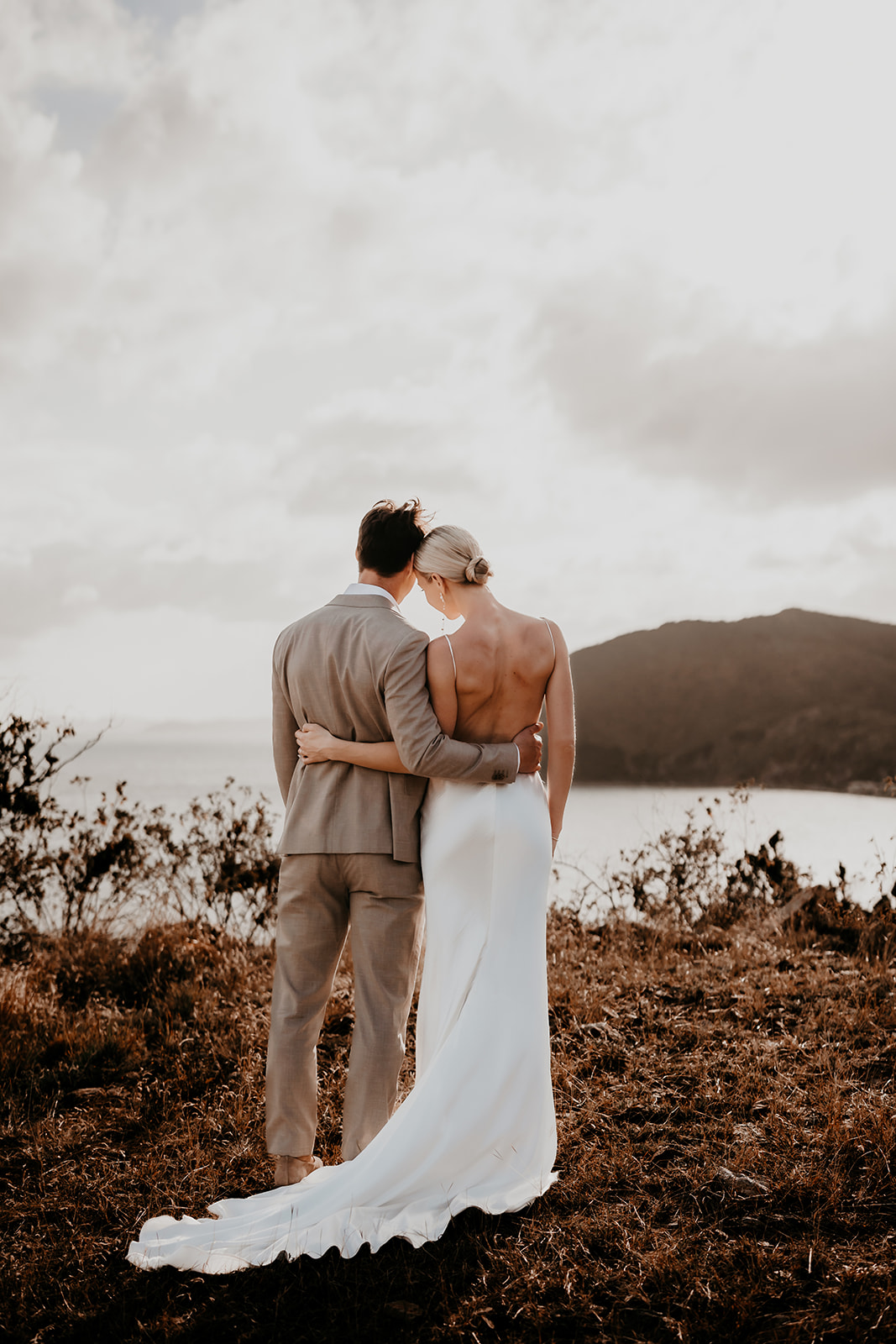 Candid shot of the bride and groom embracing looking out onto the ocean in the British Virgin Islands.