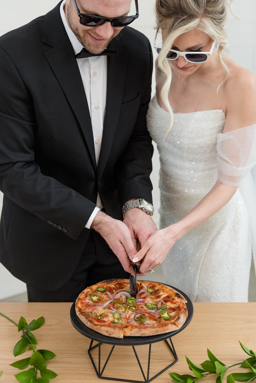 La Pointe Events bride and groom have a pizza pie