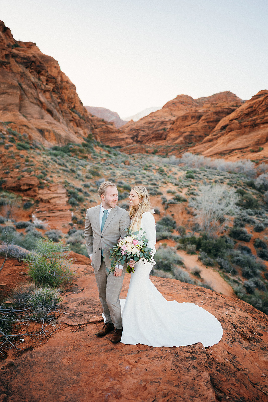 bride and groom in red rock canyon