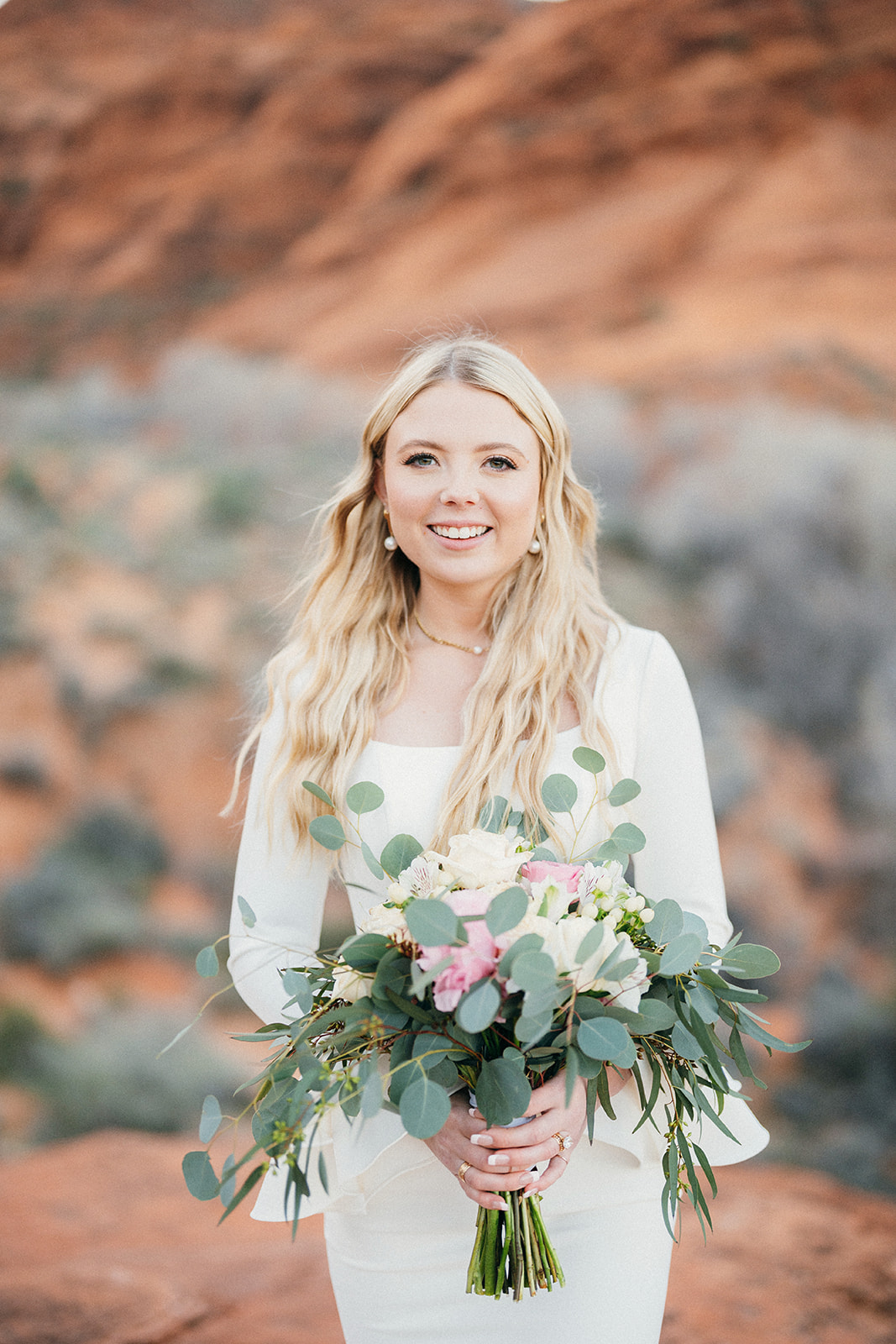 bride smiles with bouquet