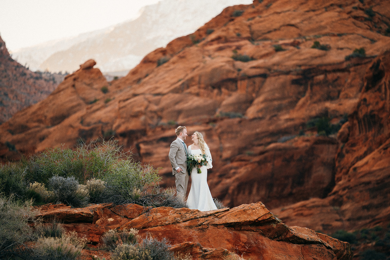 couple in front of red rock cliffs