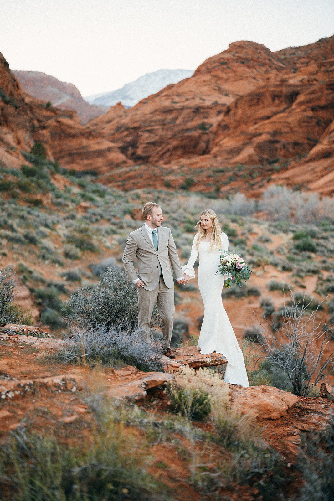 couple looking at each other in red rock canyon