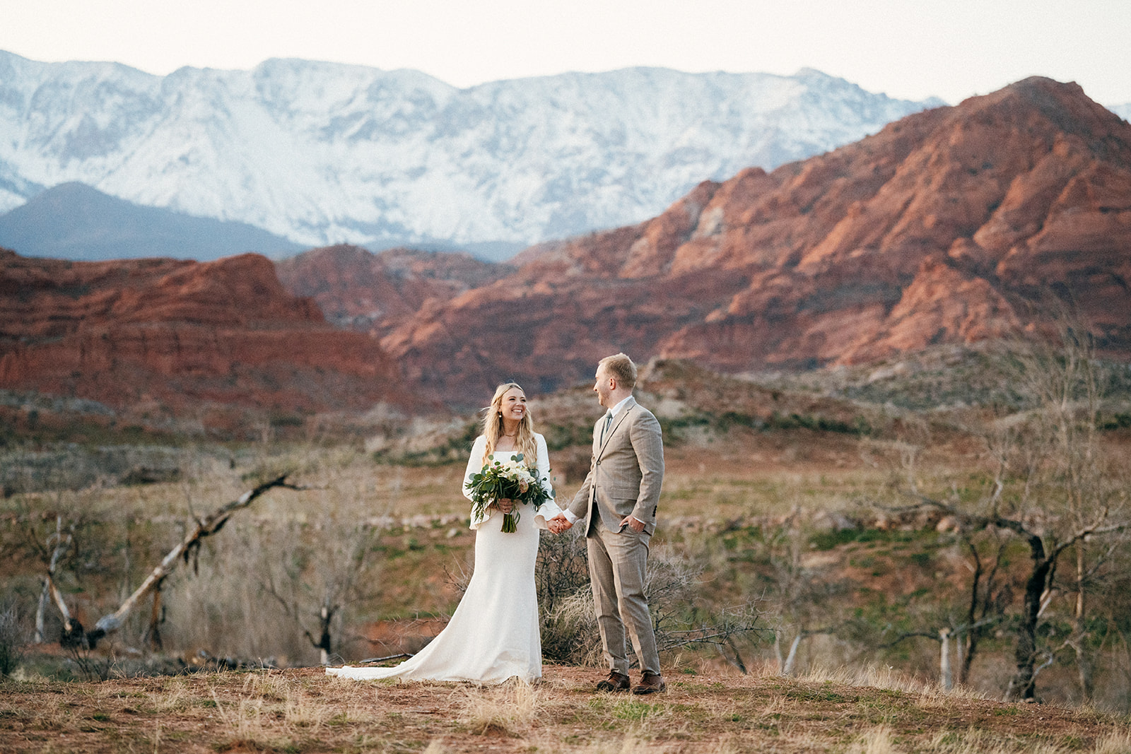 couple with red rock canyon and pine mountain in background