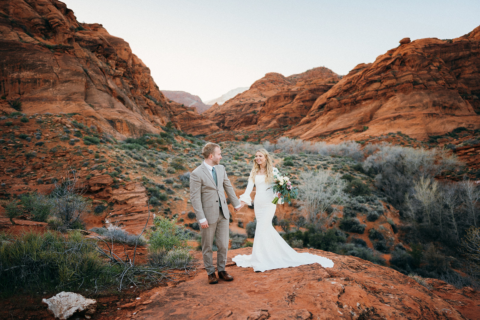 couple walking in red rock canyon