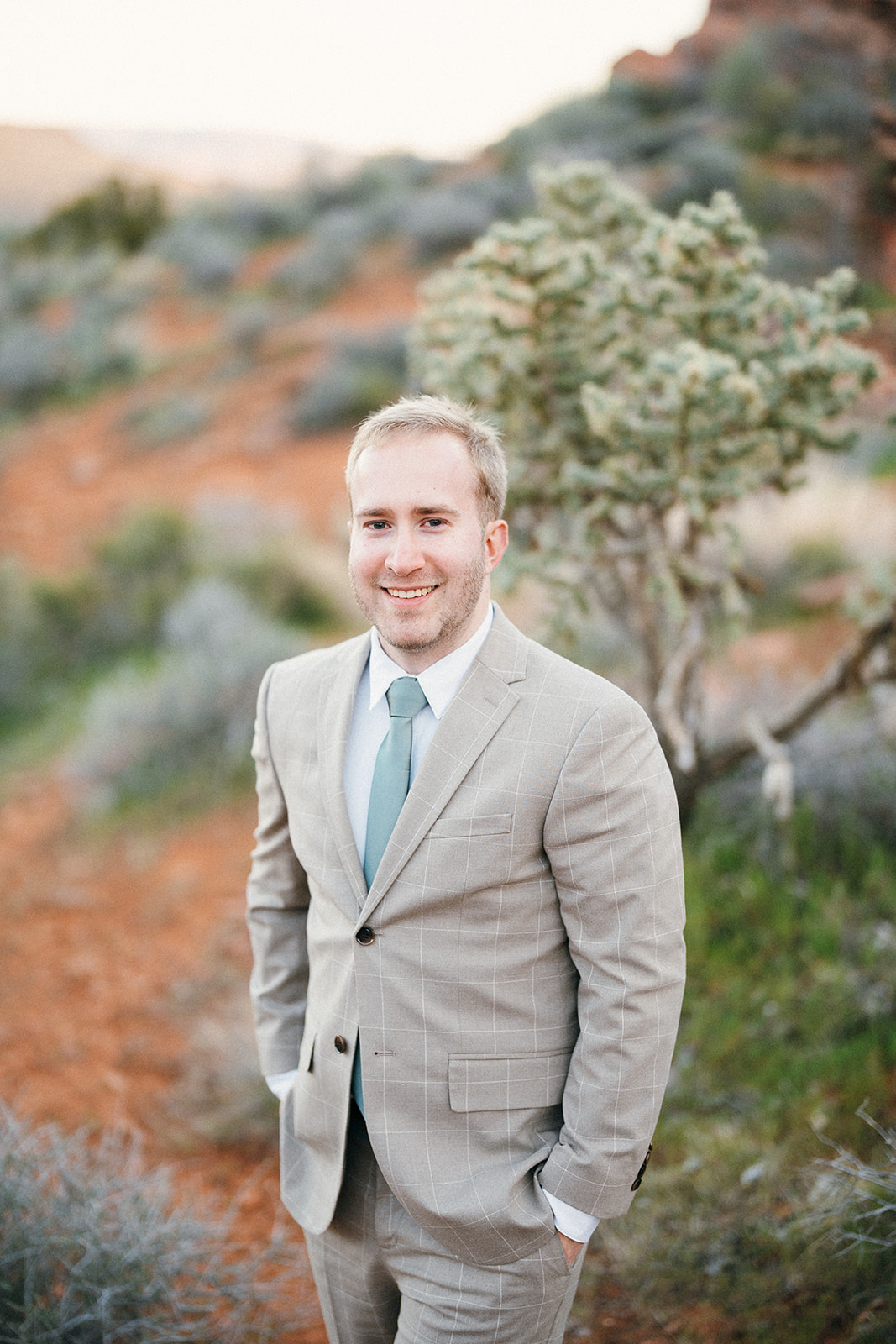 groom in front of a cactus
