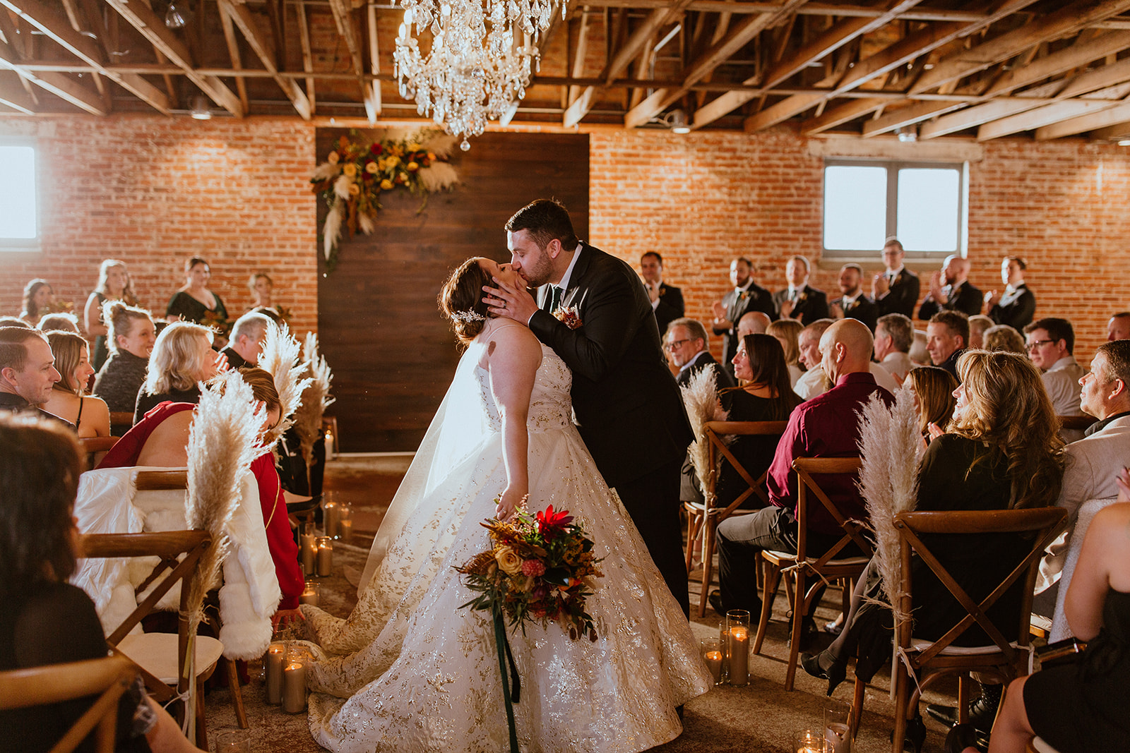 Couple kisses at the end of the aisle after getting married