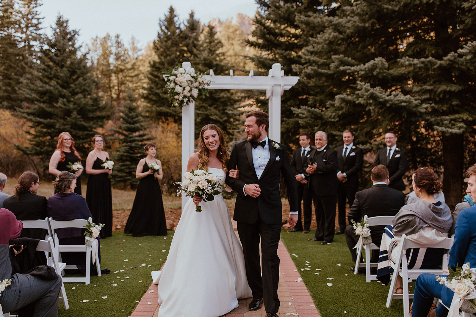 Couple walks down aisle after wedding ceremony in mountains in Colorado