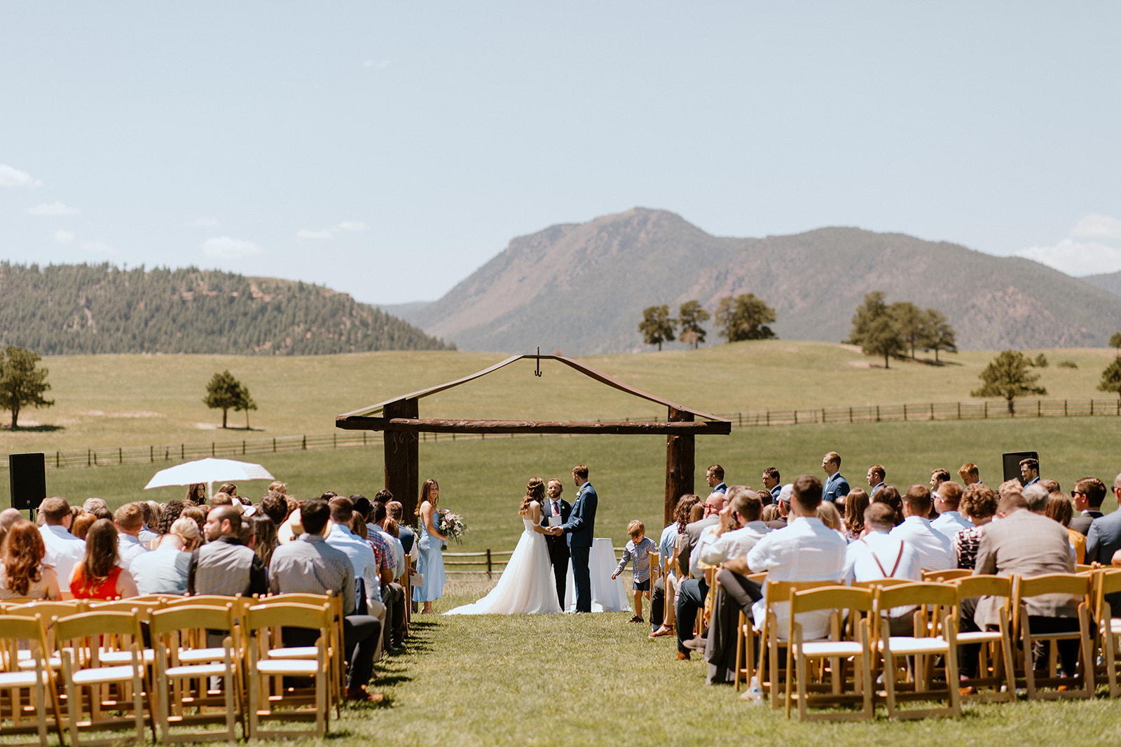 Couple gets married surrounded by friends and family in a field in Colorado. 