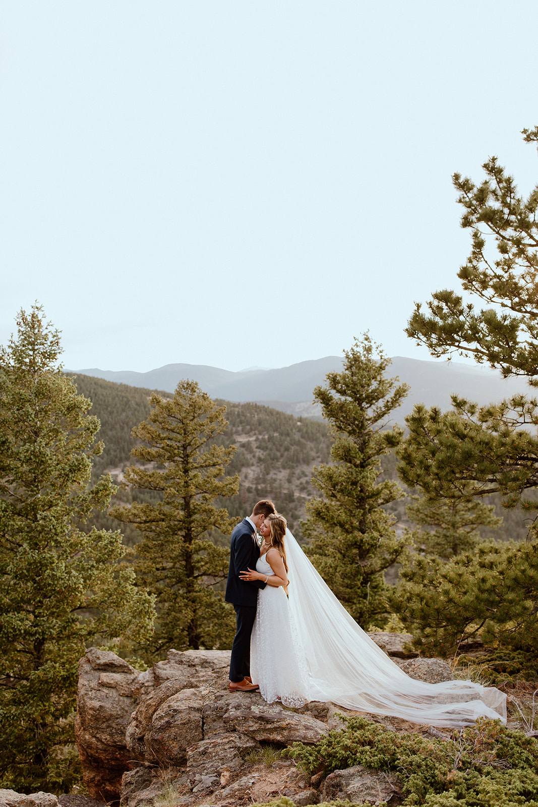 Bride and groom pose with the Colorado Rocky Mountains in the background at North Star Gatherings. 