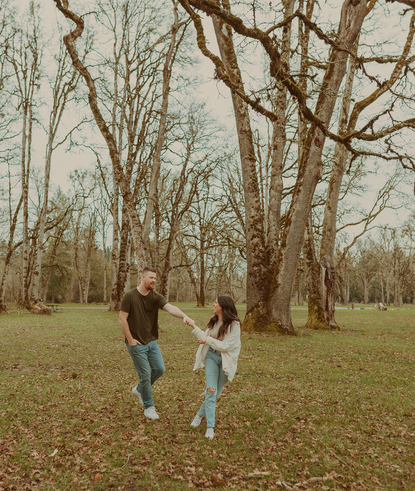 A couple having fun during their engagement photos in Champoeg State Park in Saint Paul, Oregon