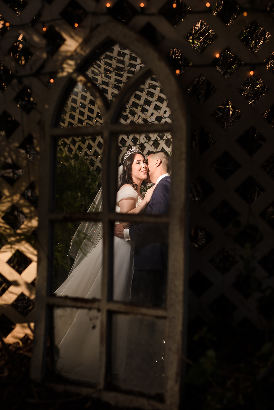 A creative reflection photograph of the newlyweds in the tunnel at The Orchard, CA