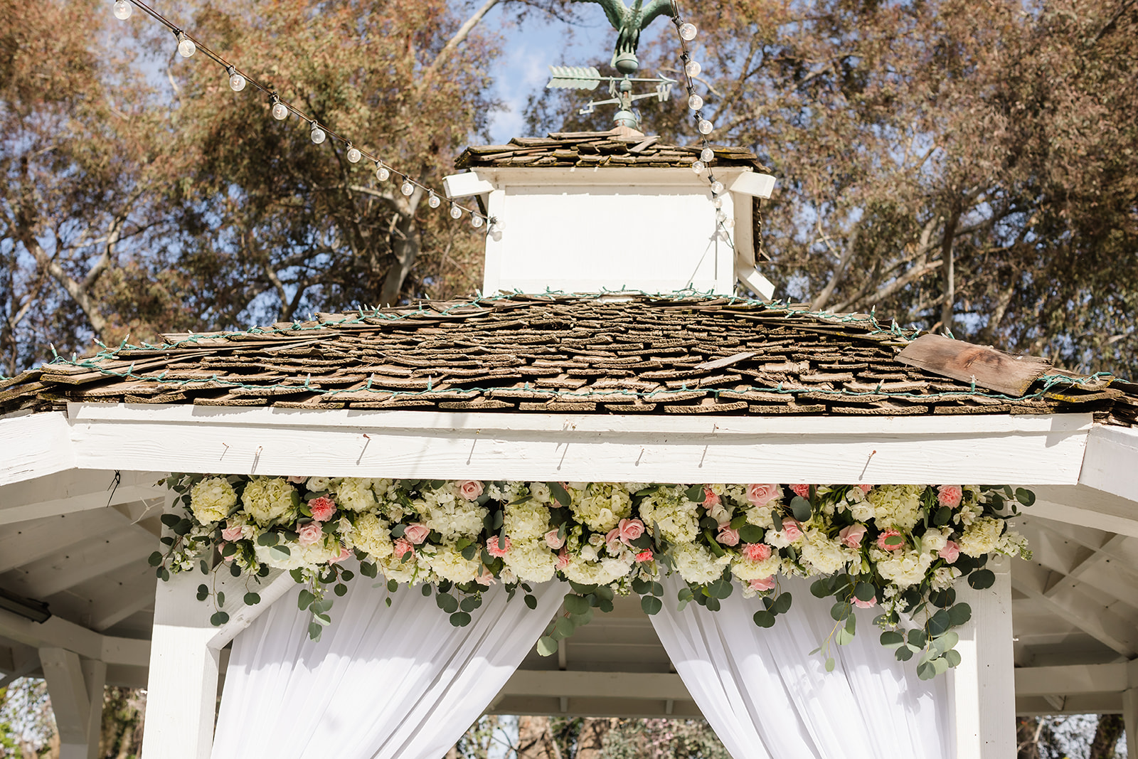 Pink and white roses used as decor across the top of the gazebo at The Orchard