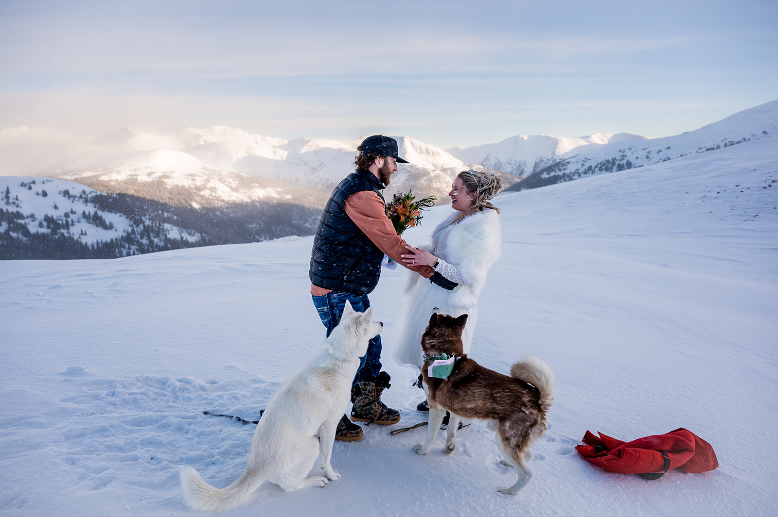 a couple embraces in a cold mountain top ceremony on Loveland Pass