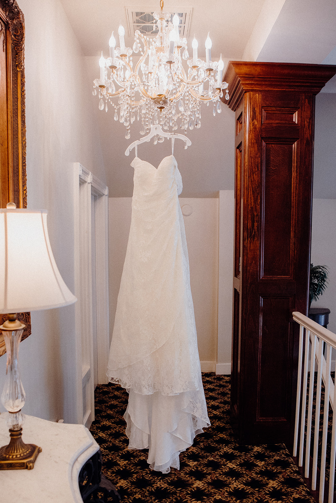 Bridal gown hanging from the chandelier the woodwinds
new haven wedding photographer