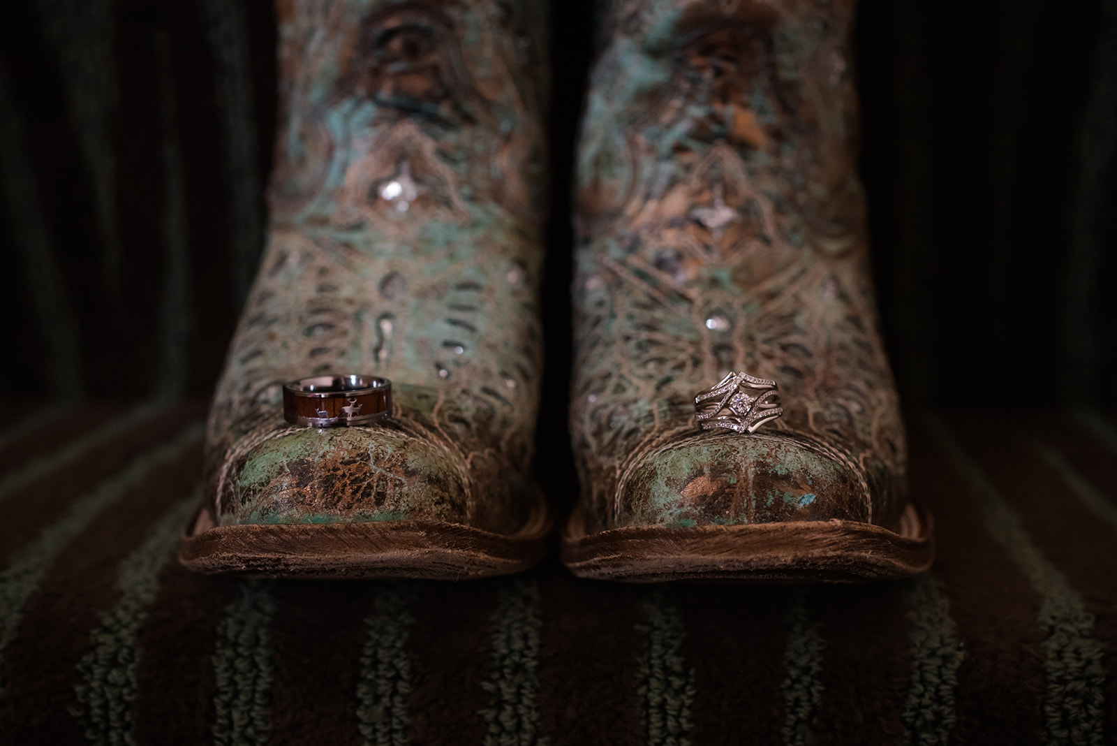 custom rings sit on the toe of the bride's sparkly cowgirl boot