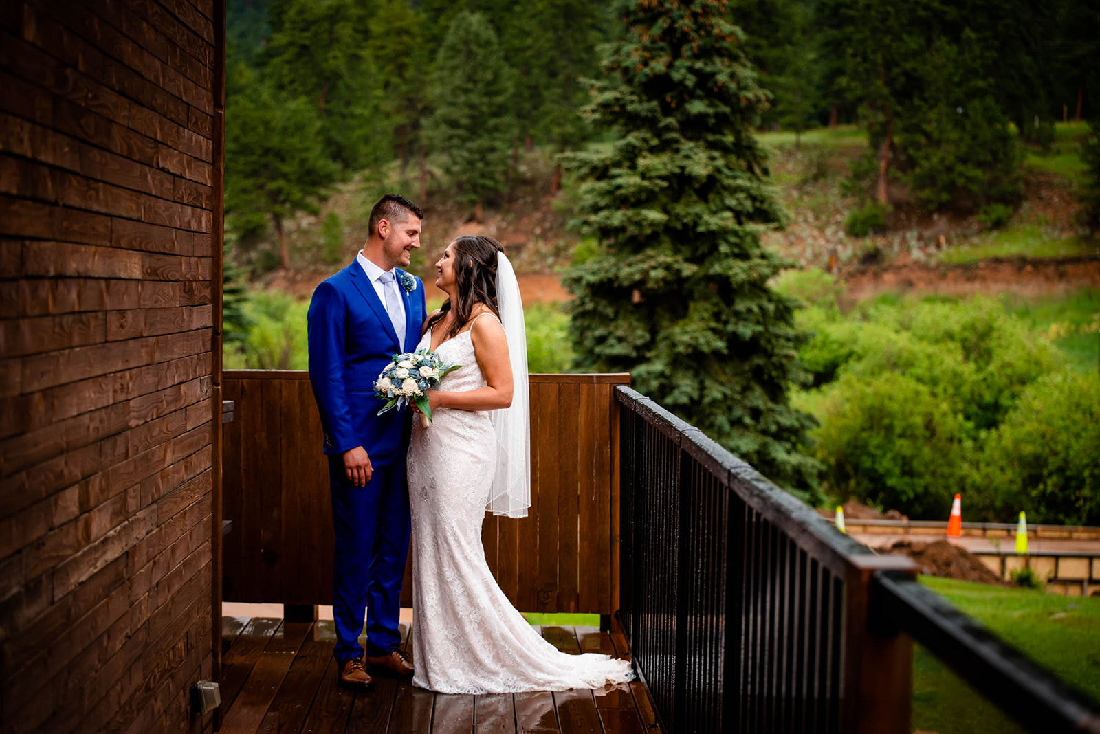 a couple has a moment together on the deck at Wedgewood mountain view ranch in pine, co
