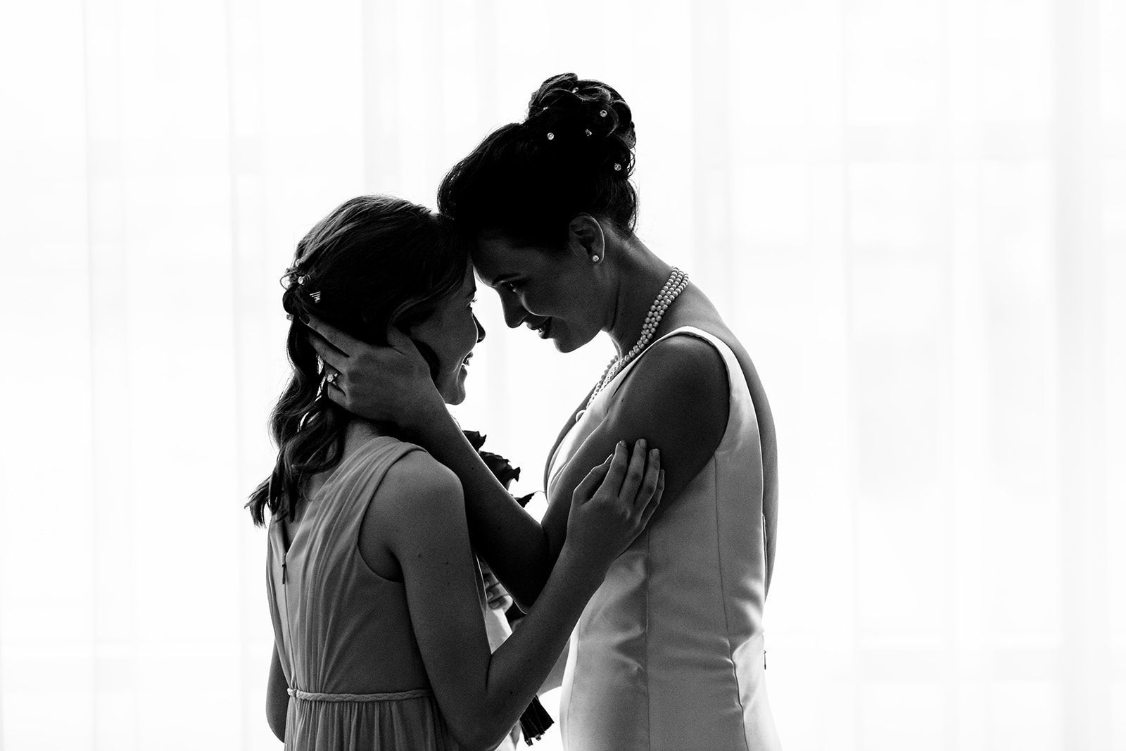 Emotional black and white photo of bride and daughter