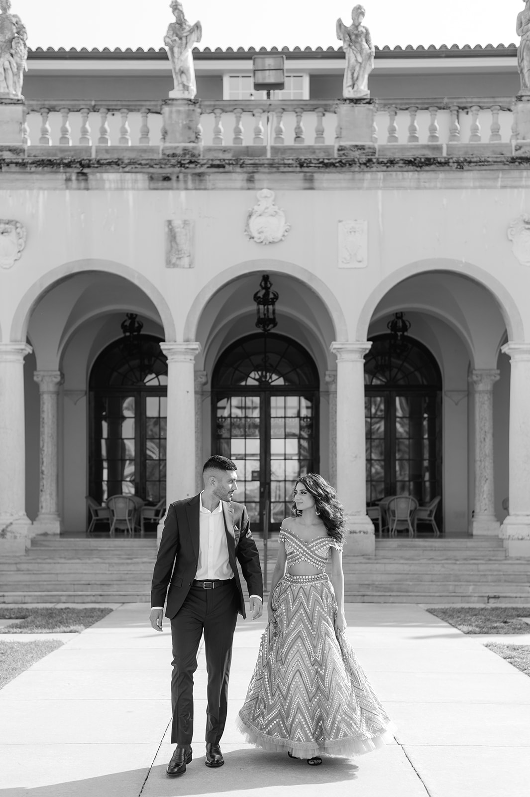 "Indian bride and groom looking stunning in front of Ca' d'Zan at the Ringling Museum"
