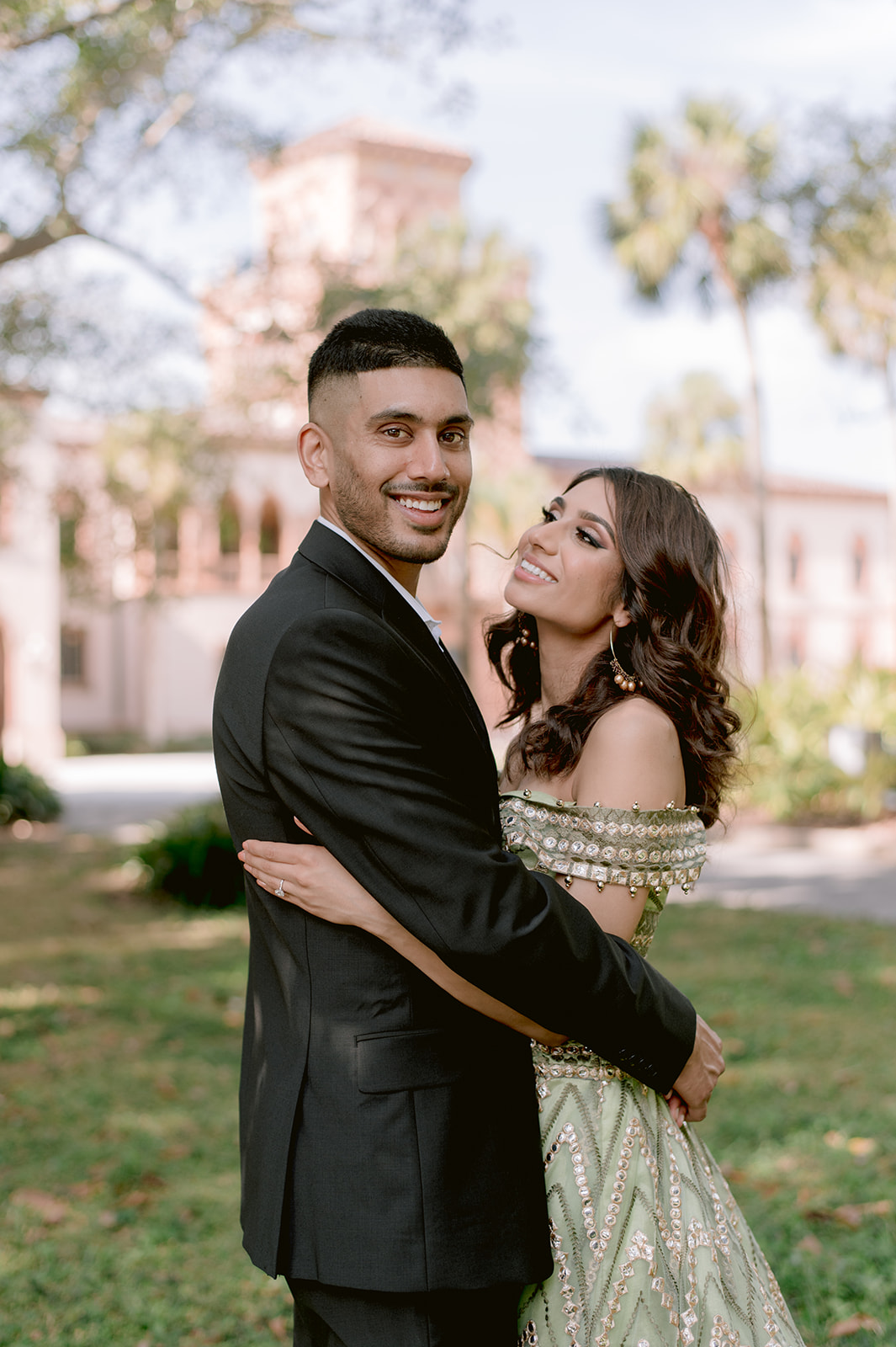 "Indian bride and groom in traditional attire showcase their love during their engagement session at the Ringling Museum