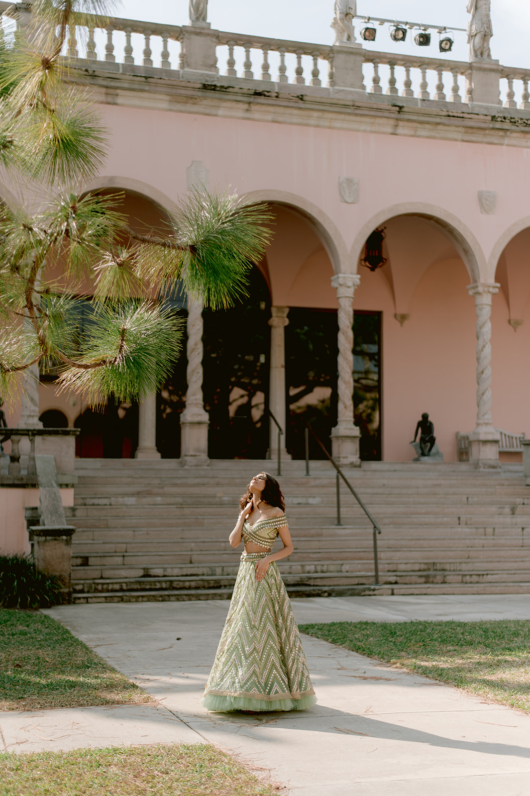 "Indian couple posing in front of the Ca' d'Zan mansion at the Ringling Museum"
