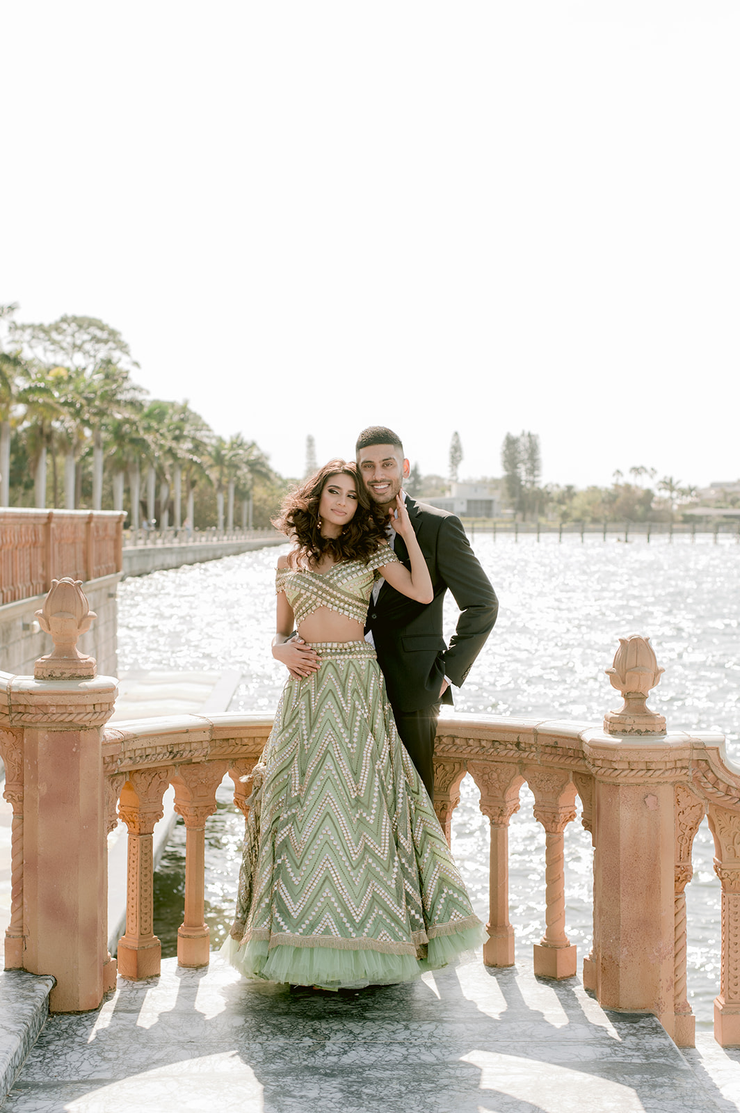 "Indian couple in traditional attire showcases their love and beauty at the Ringling Museum's Ca' d'Zan mansion"
