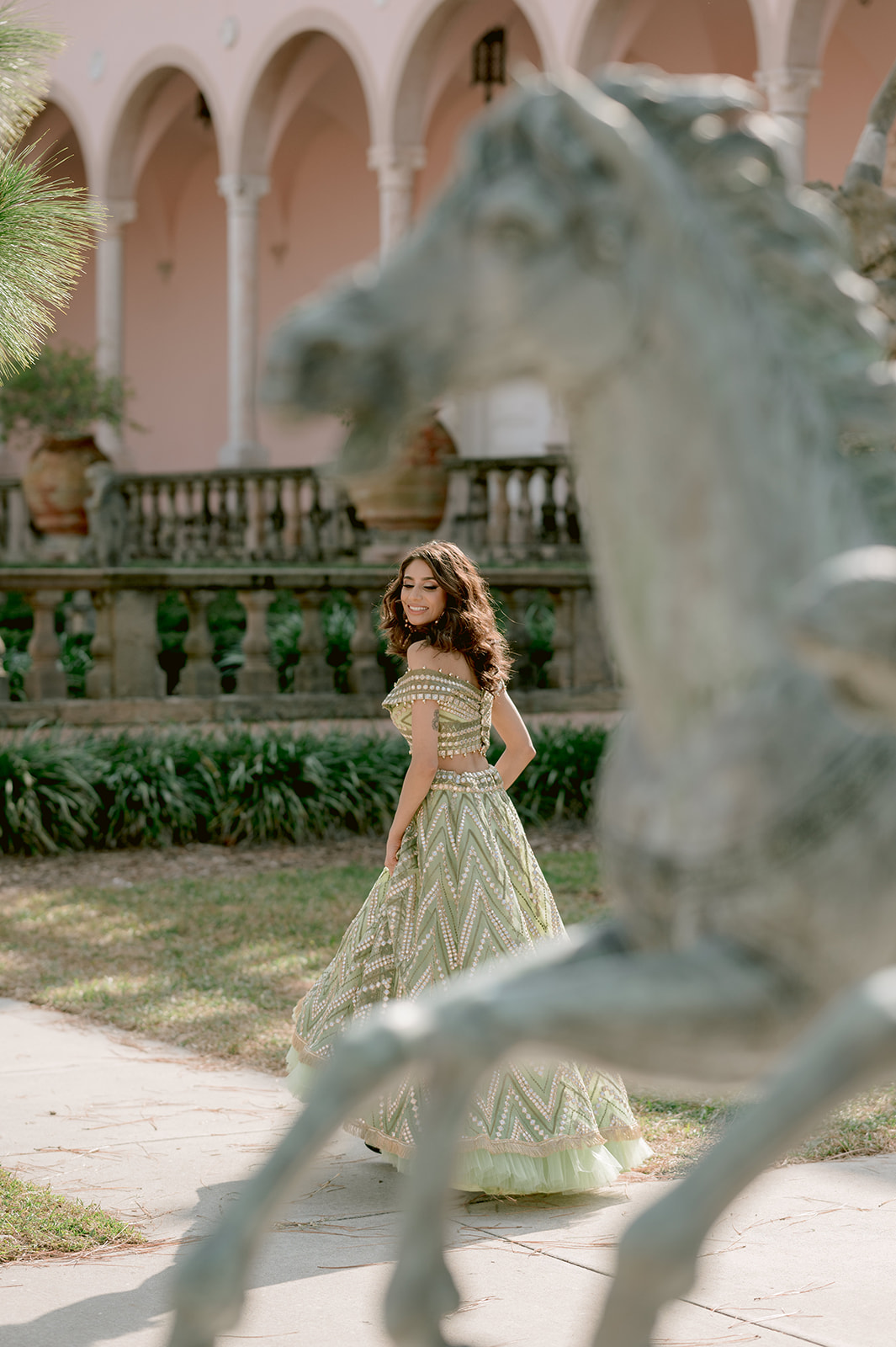 "Indian engagement session with stunning pastel green and gold outfit and Ca' d'Zan mansion"
