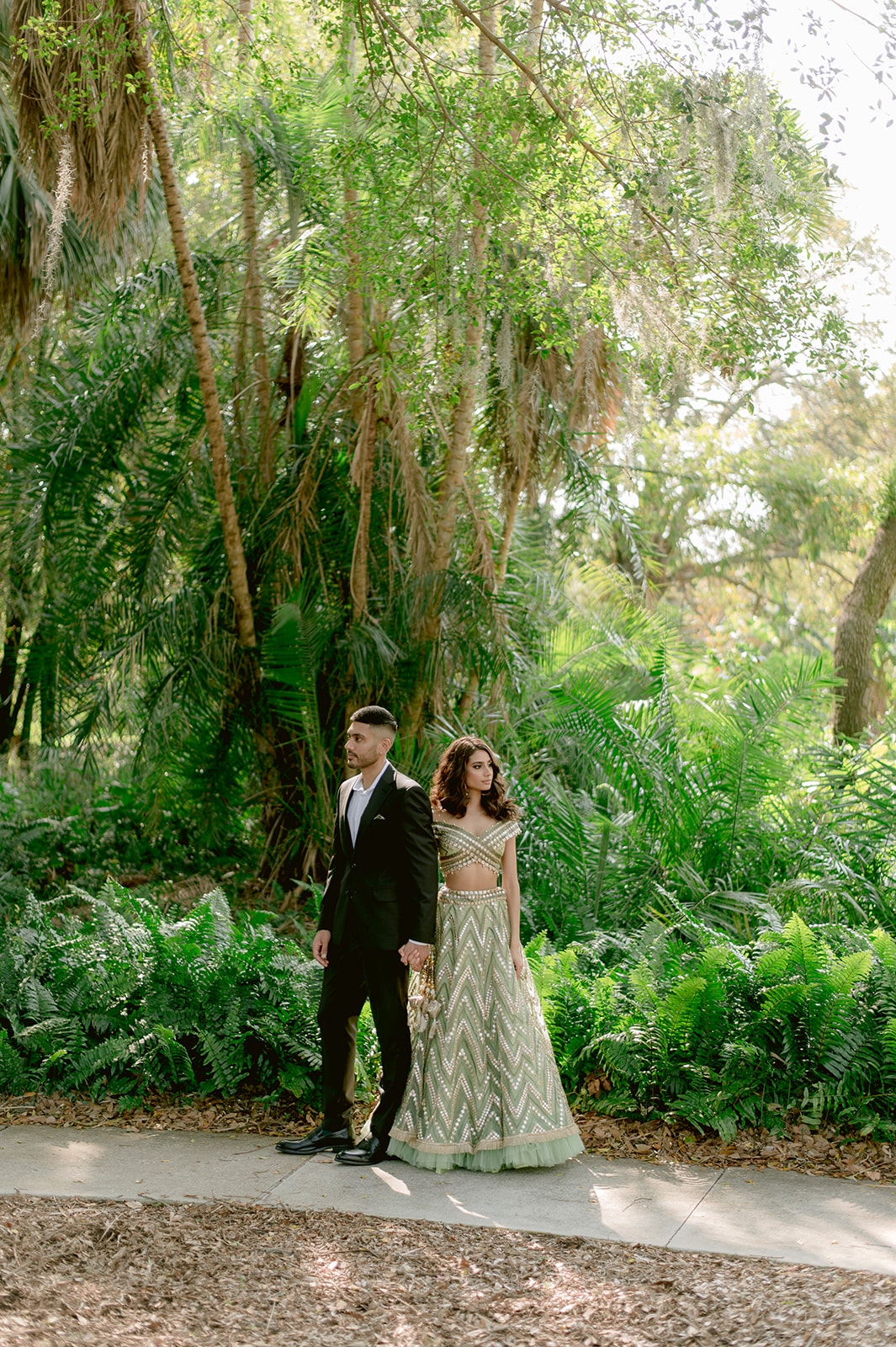 "Ringling Museum engagement shoot features pastel green and gold Indian outfit and stunning location"
