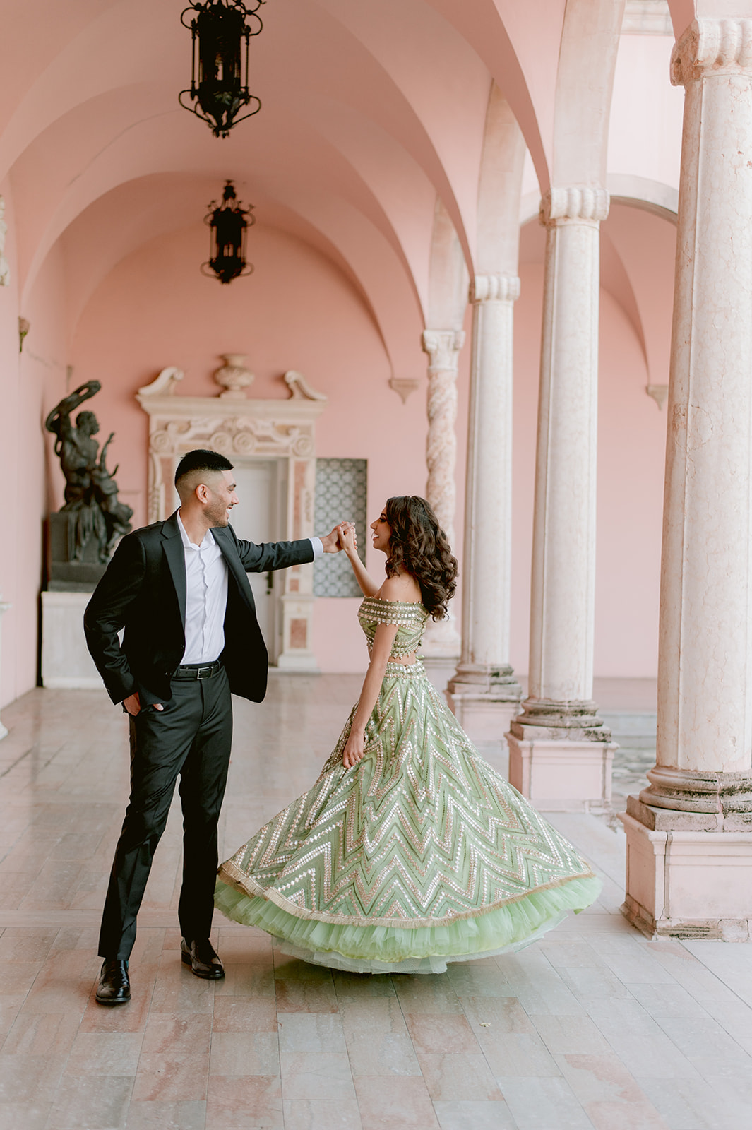"Stunning portrait of Indian bride and groom in front of Ca' d'Zan mansion"
