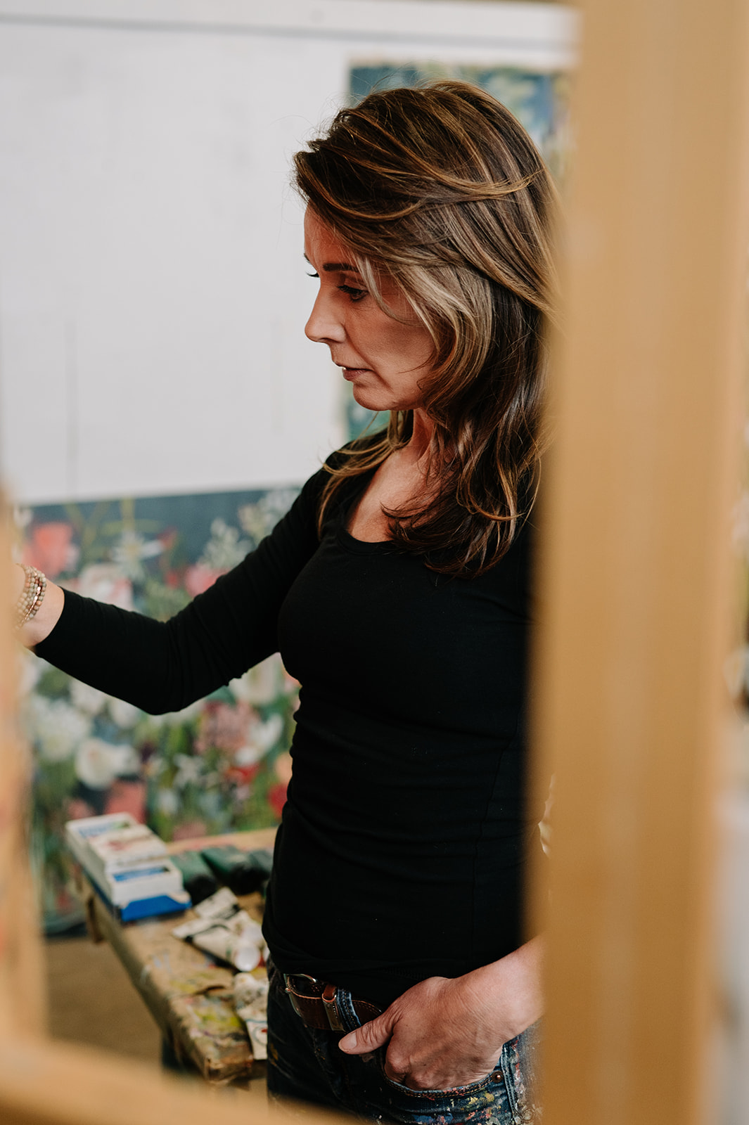 woman painting canvas on easel 