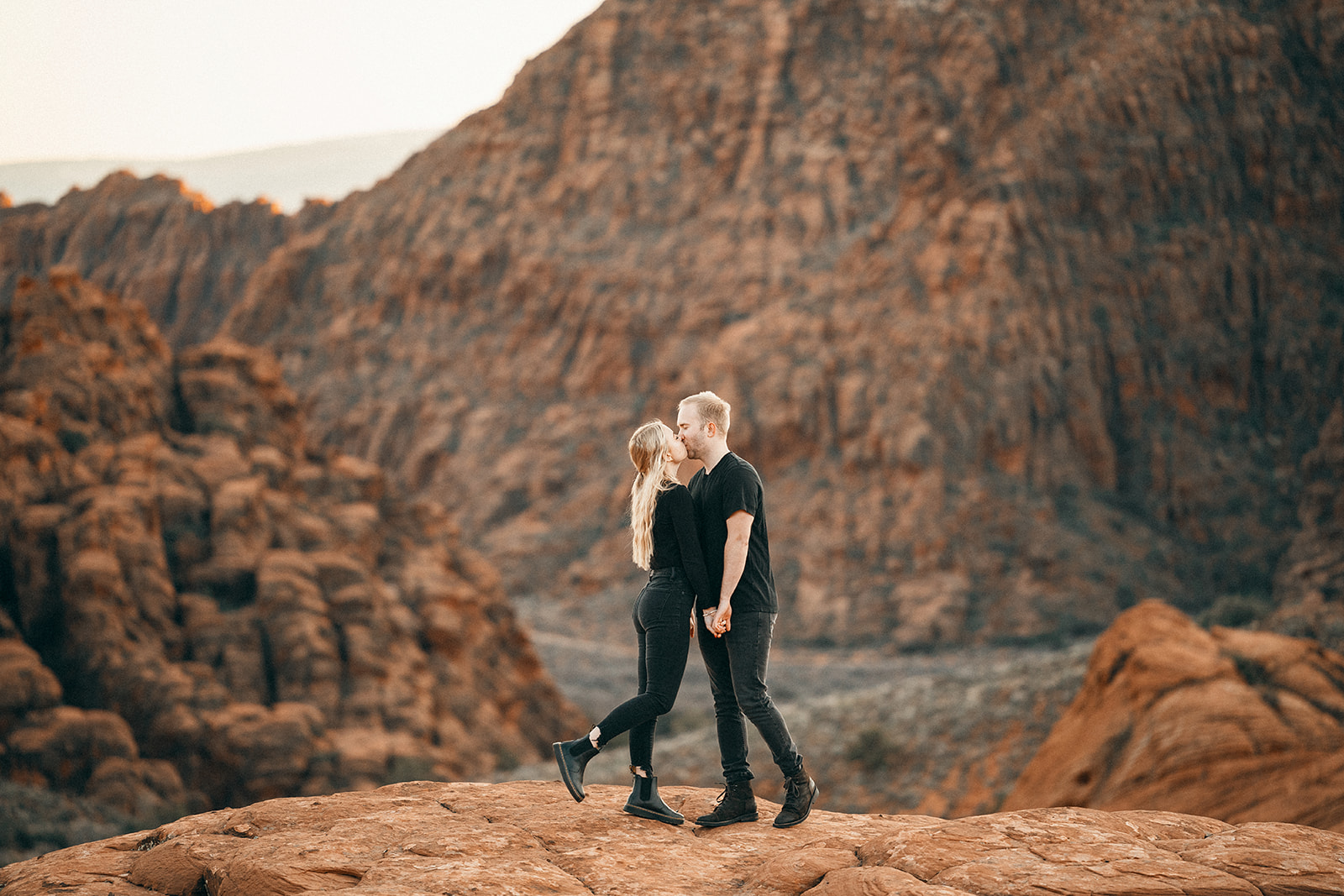 a kiss at snow canyon during an engagement session