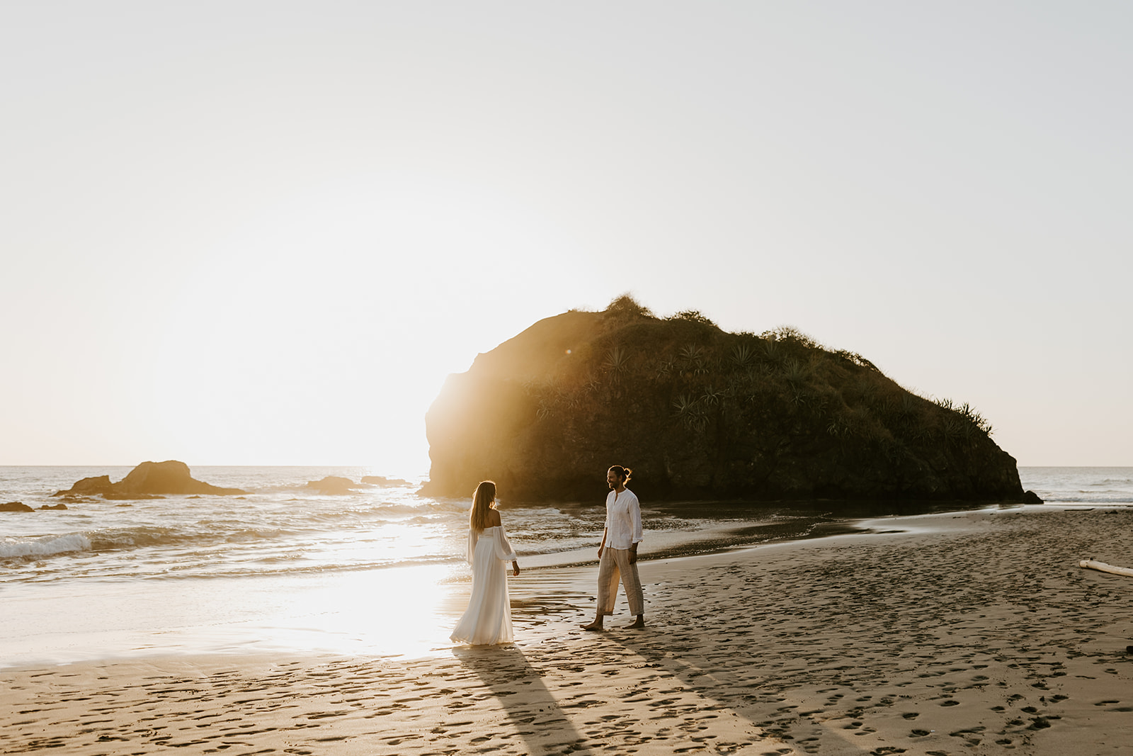 A couple at sunset during their destination elopement on the beach. 