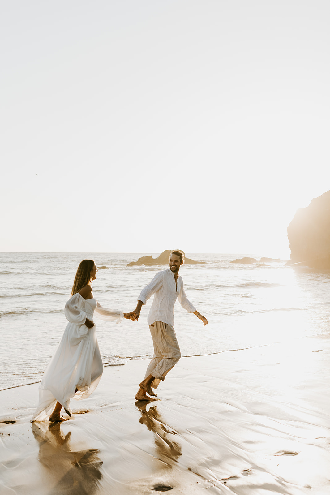 A couple running on the beach for their destination elopement in Costa Rica. 