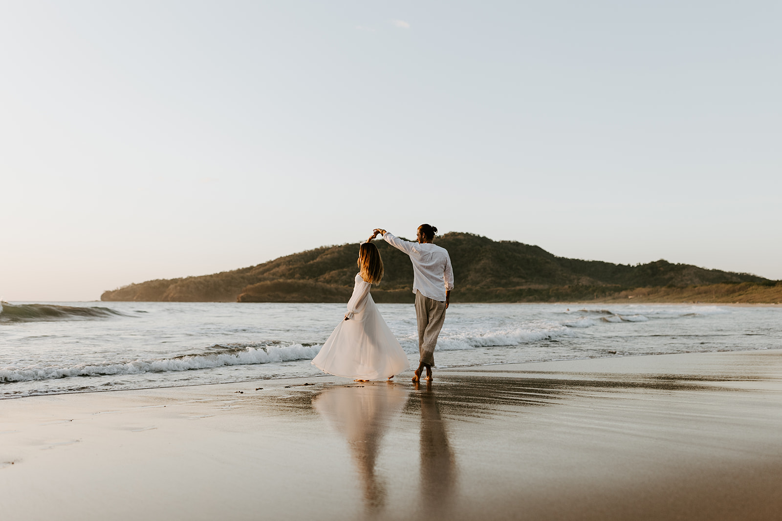 A sunset elopement in Tamarindo, Costa Rica. Couple in the water. 