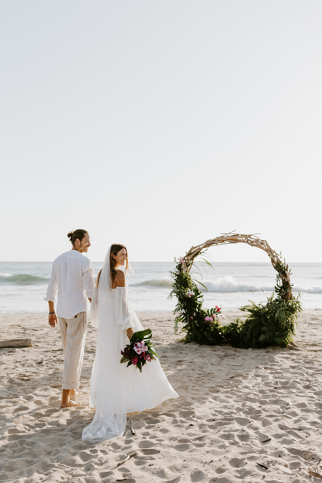 A flower arch on the beach for an elopement in Costa Rica.