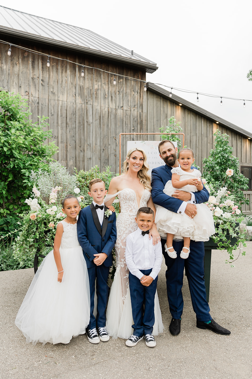 bride and groom with kids at farm to table wedding by jess collins photography