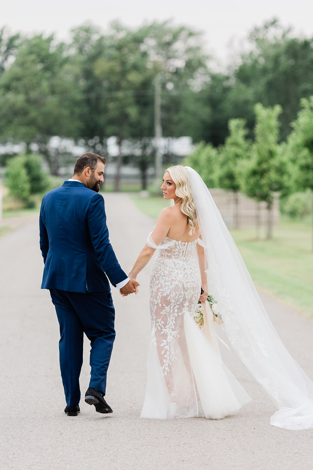 bride and groom on path at farm to table wedding by jess collins photography