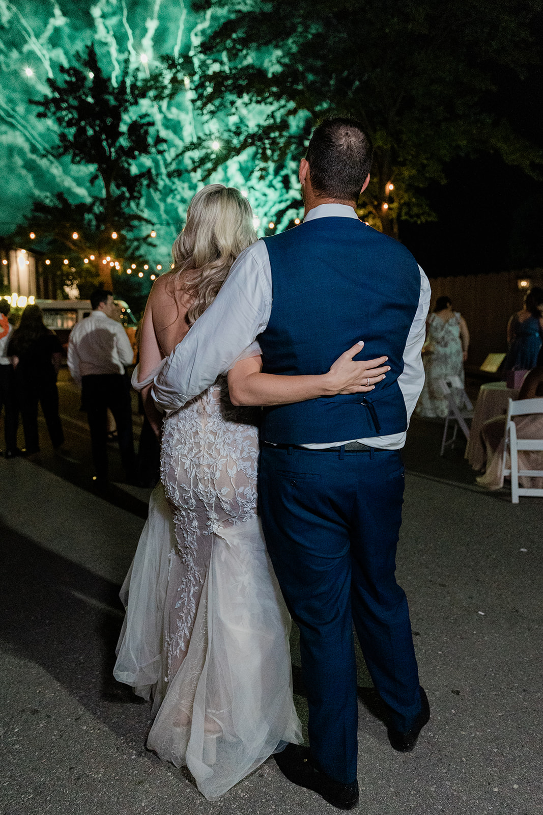 bride and groom watch fireworks at farm to table wedding by jess collins photography