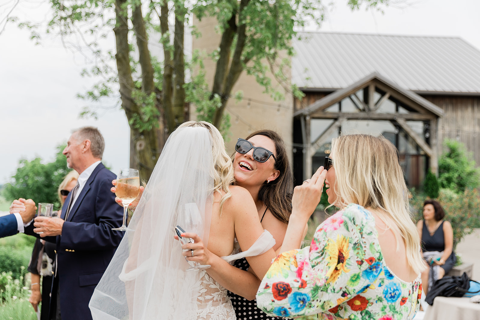 bride hugging cocktail hour at farm to table wedding by jess collins photography