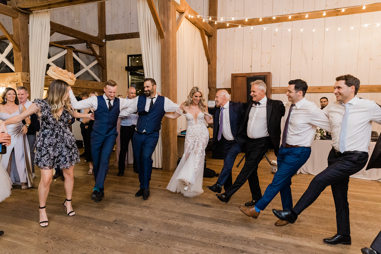 dancing traditional greek bread dance at farm to table wedding by jess collins photography