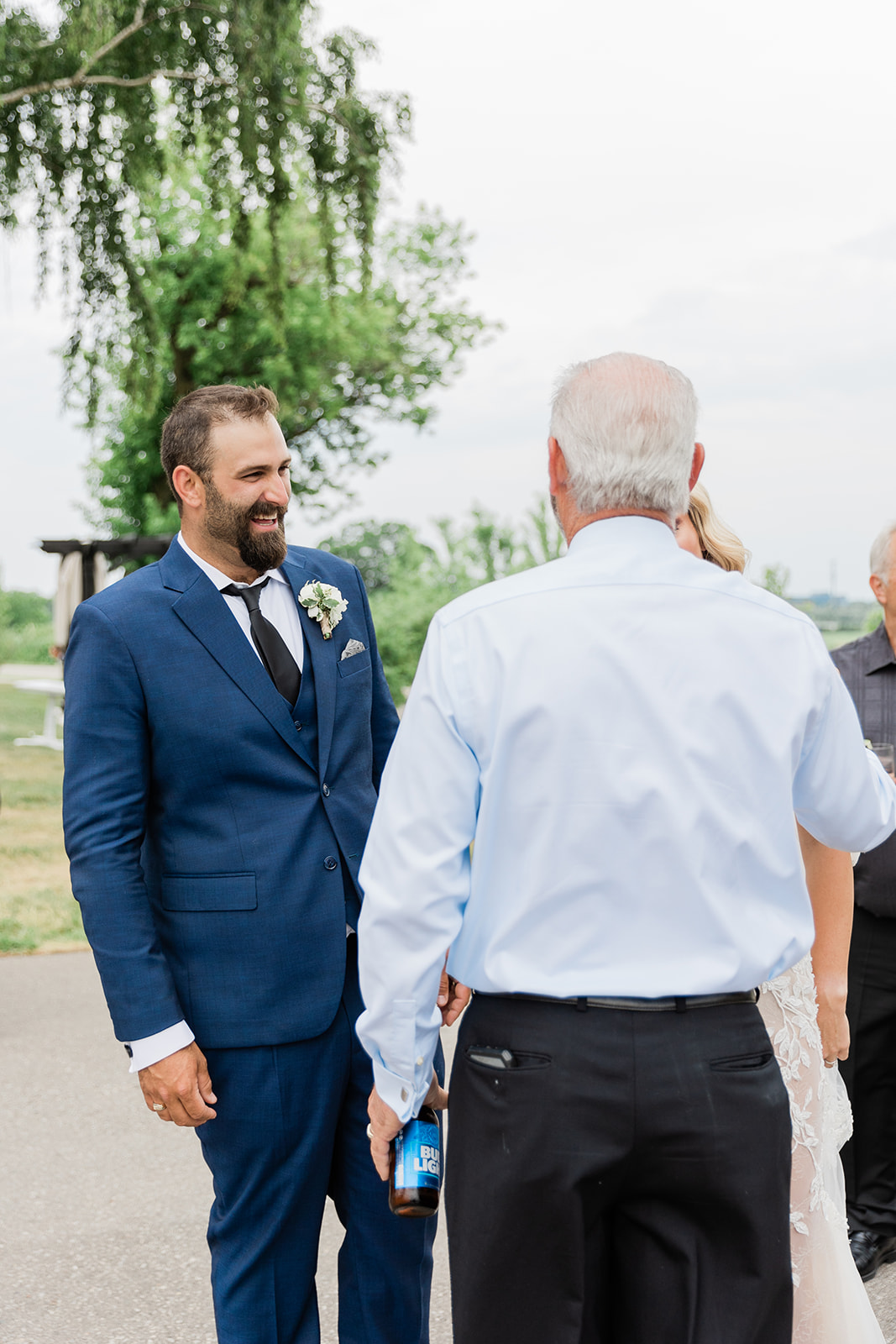 groom laughing at farm to table wedding by jess collins photography
