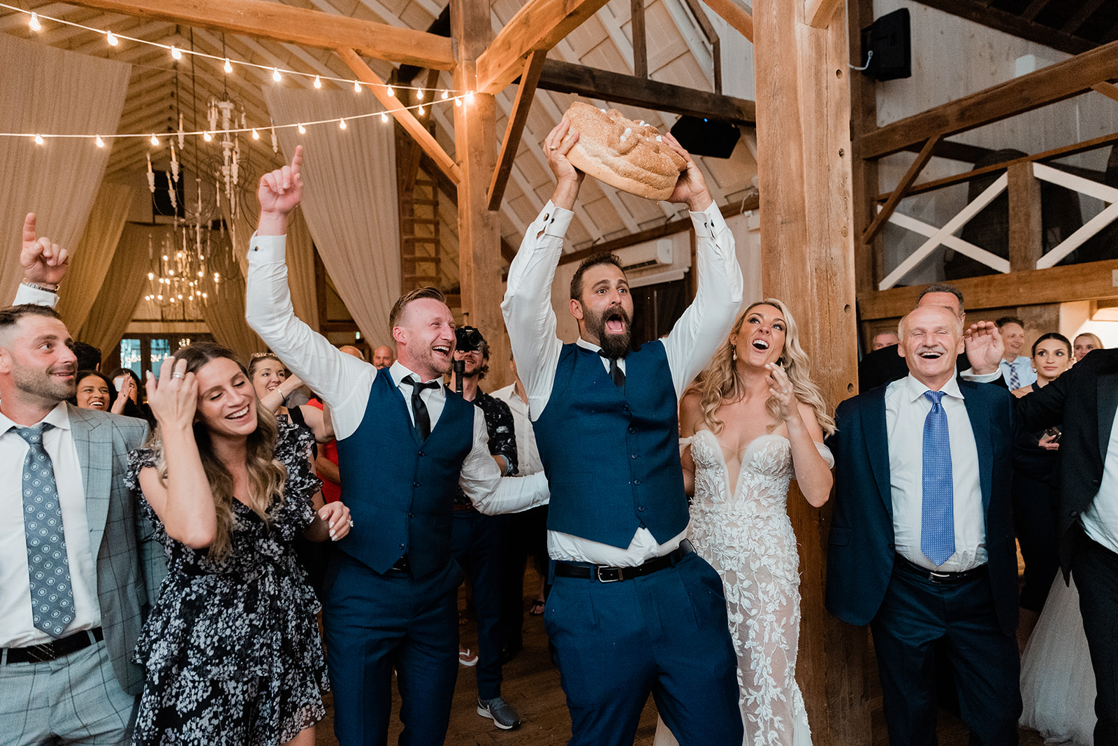 groom traditional greek bread dance at farm to table wedding by jess collins photography