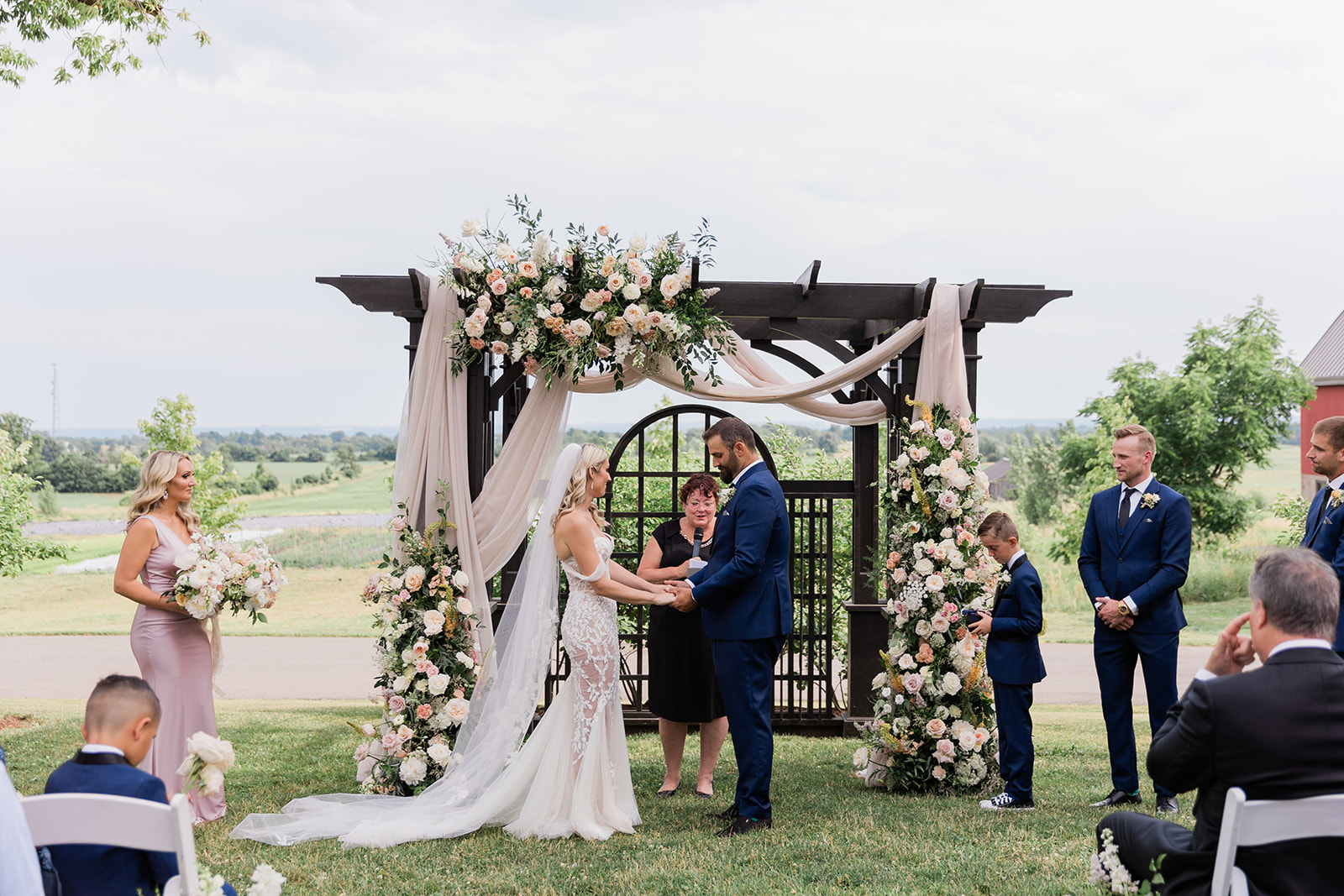 wedding ceremony bride and groom at farm to table wedding by jess collins photography